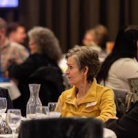 three people at table talking